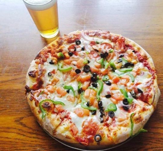 deliciously looking pizza and a glass of beer